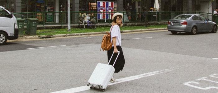 korean girl carrying luggage