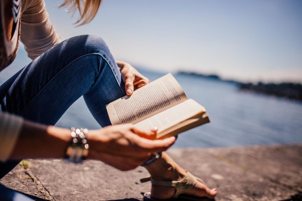Woman reading on the shoreline 