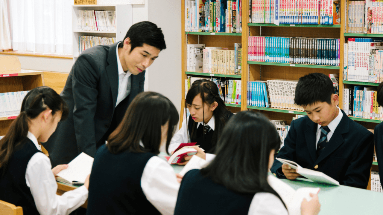 Best books to learn Japanese stacked on a desk for language learners