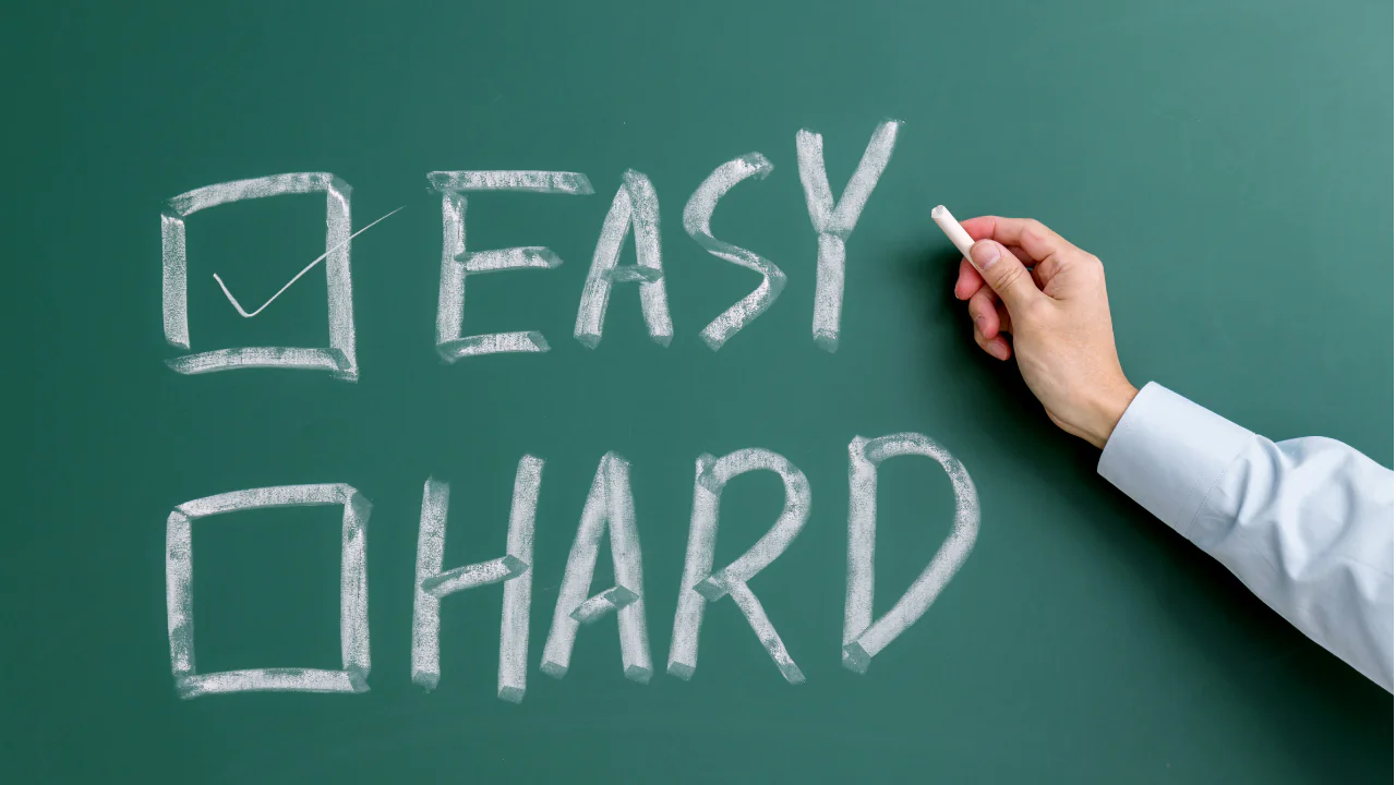 "Easy" checked on a chalkboard.